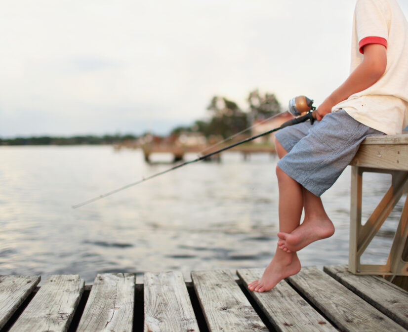 Boy Fishing off a pier