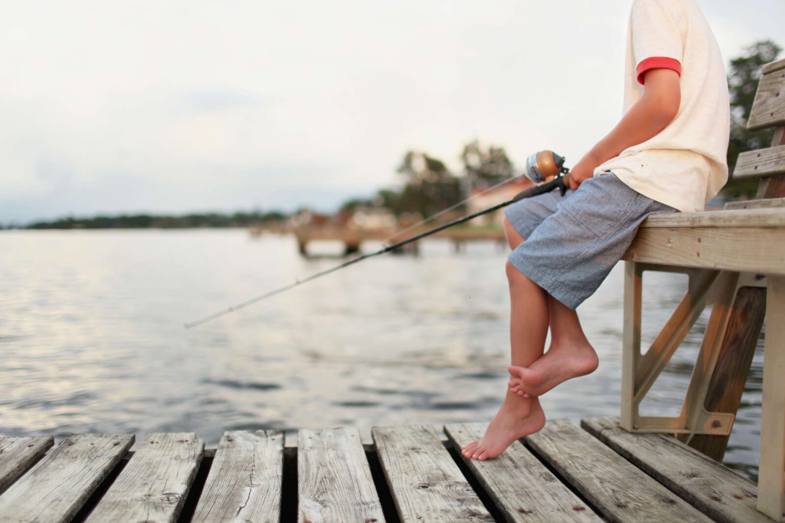 boy fishing on a dock