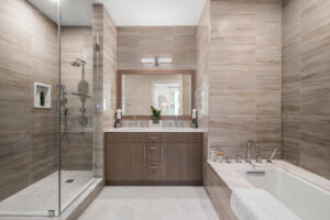 bathroom with shower stall and tub at The Beacon at Garvies Point