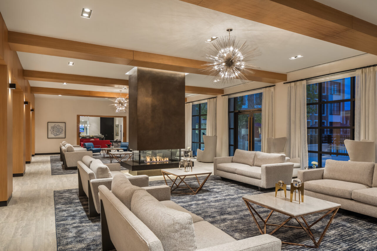 Residents lounge with fire feature and piano at The Beacon at Garvies Point